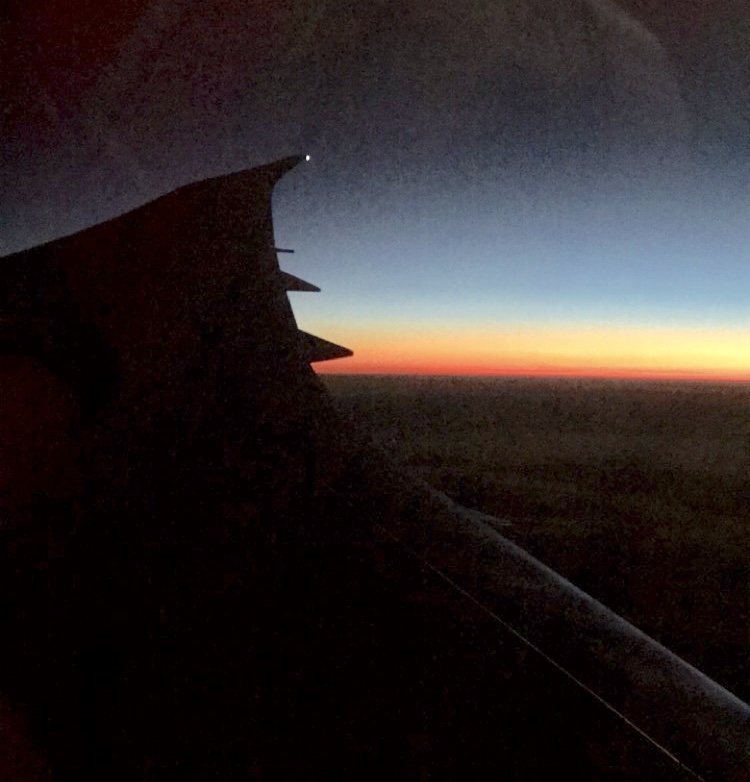 Sunrise over the wing of an airplane