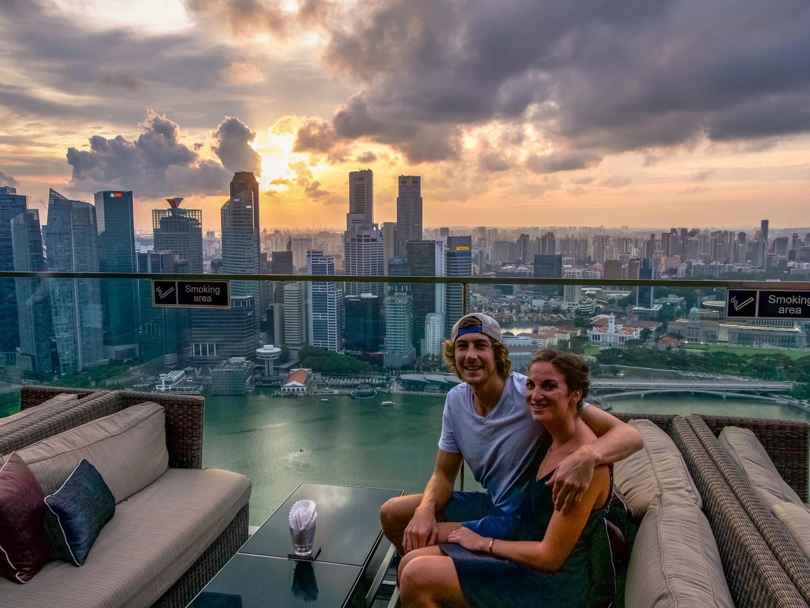 Travel couple at the rooftop bar at Marina Bay Sands hotel in Singapore