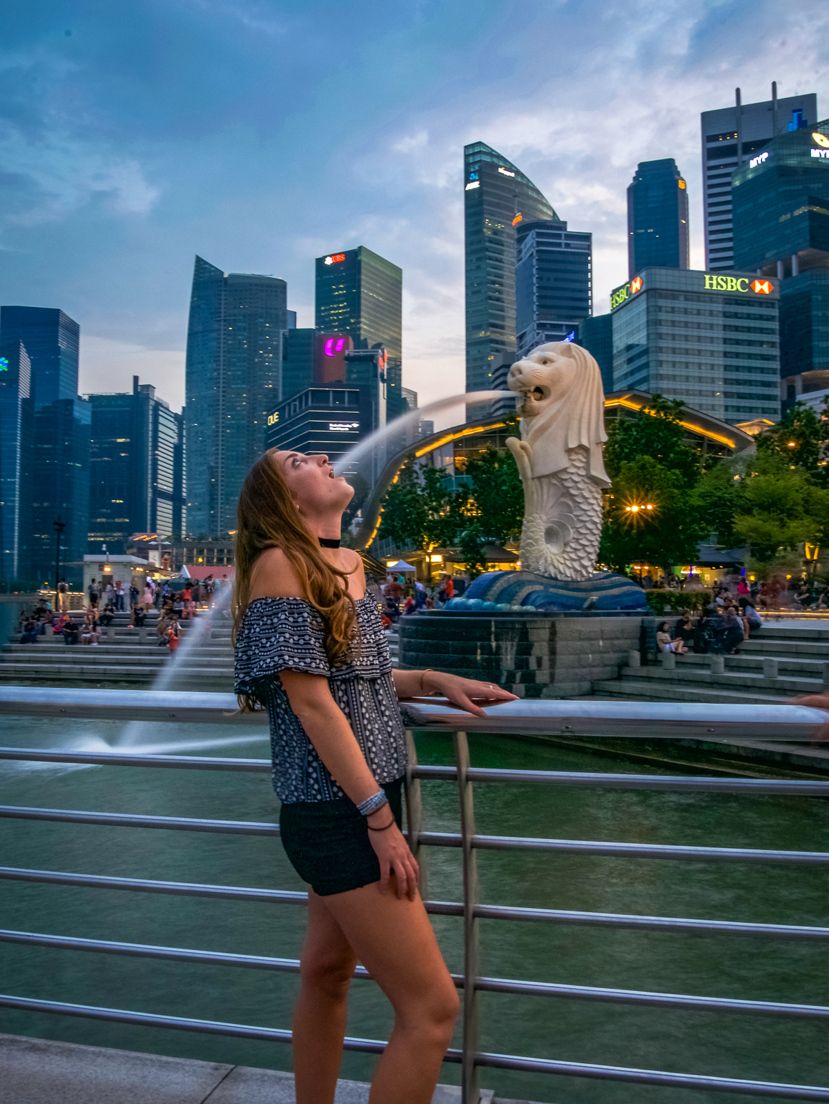 Travel girl at Singapore's Merlion Fountain
