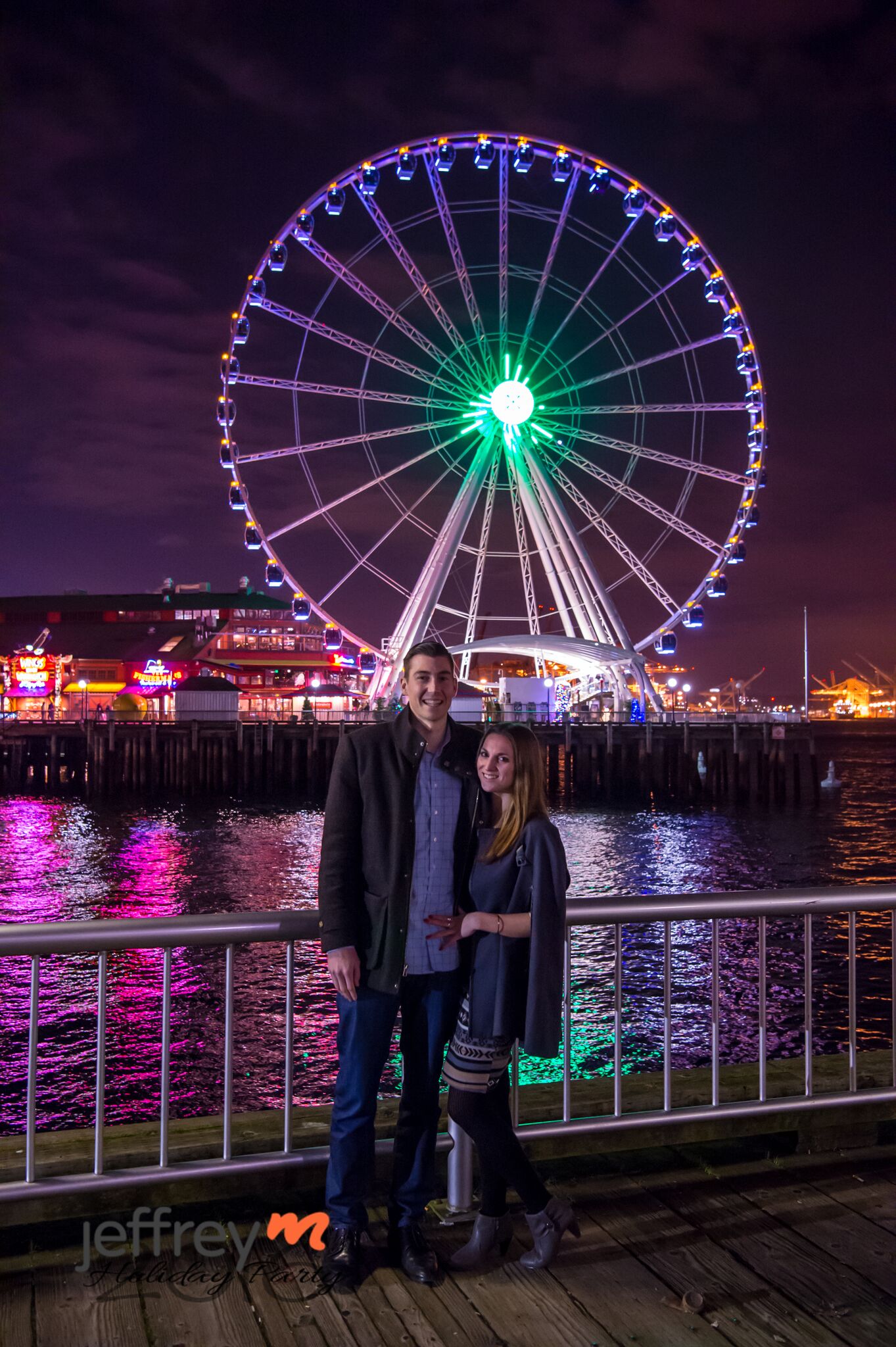 Couple in front of Seattle Great Wheel at night