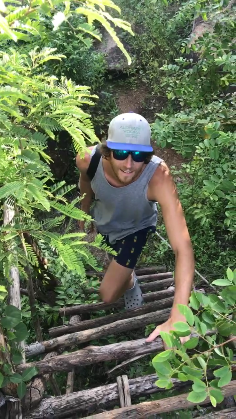 Matt climbing up the ladder to the secret wooden tower